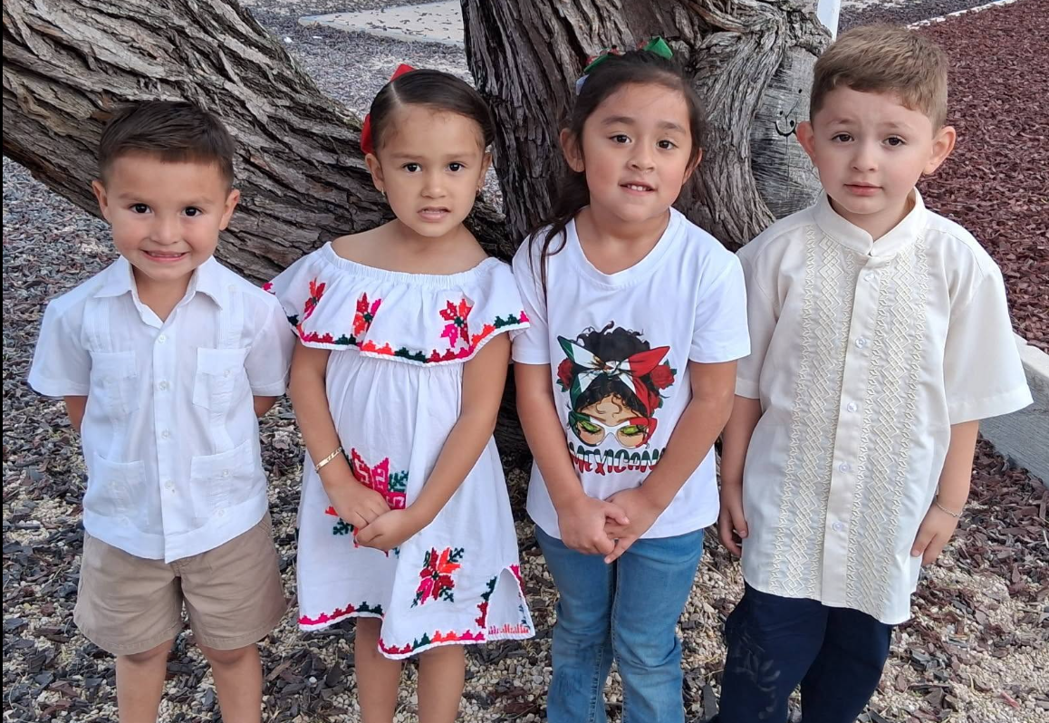 4 students dressed in Hispanic heritage clothing