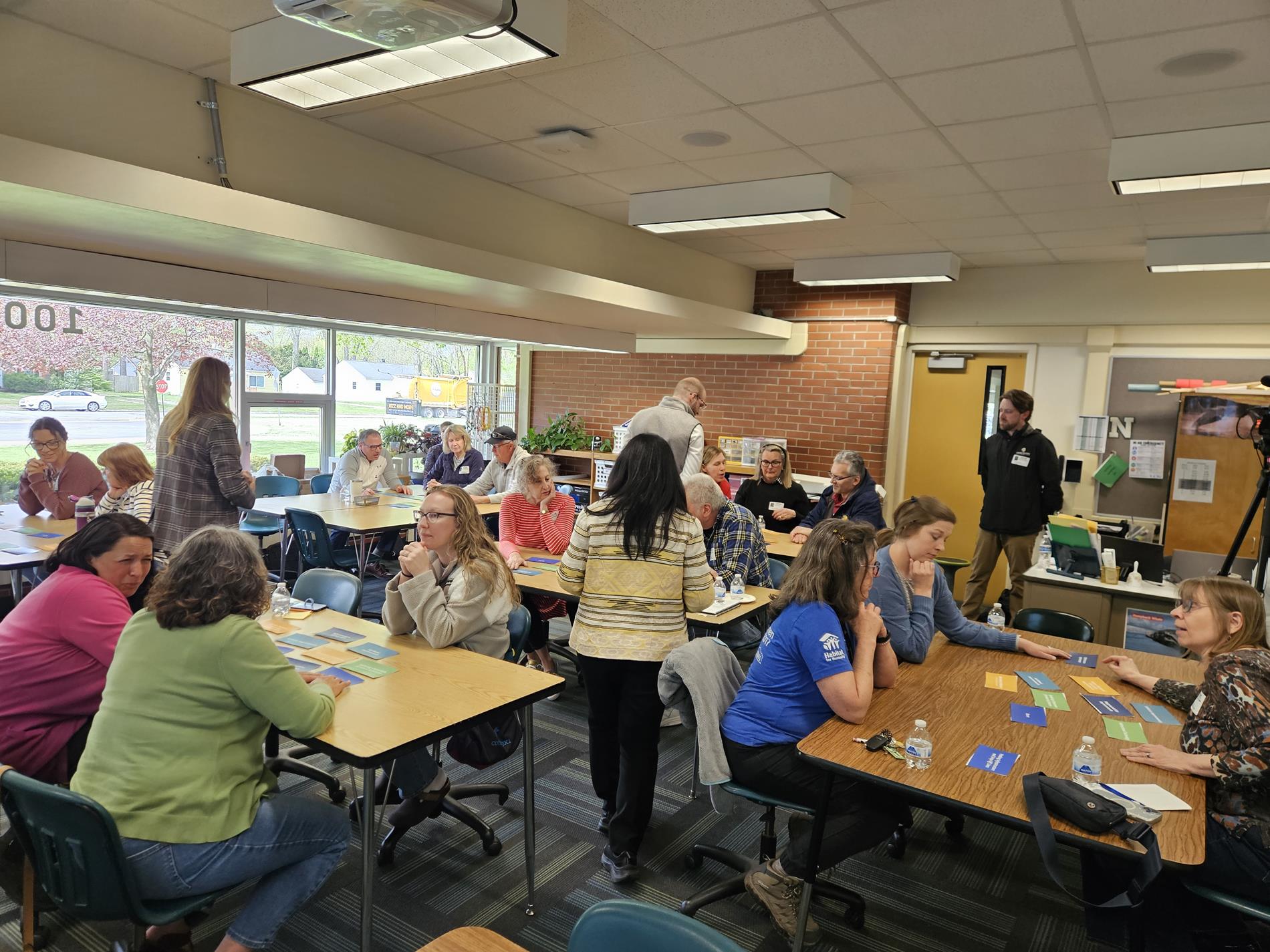 A group of community members sit in a Northeast Middle School classroom having a group discussion about bond priorities