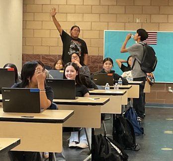 High school students working on laptops in class