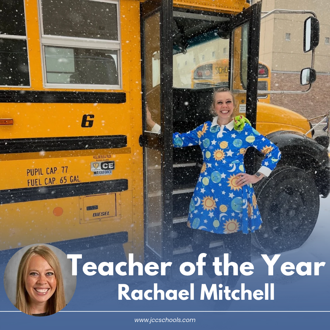 Teacher Rachael Mitchell dressed as book character Ms. Frizzell by a yellow school bus