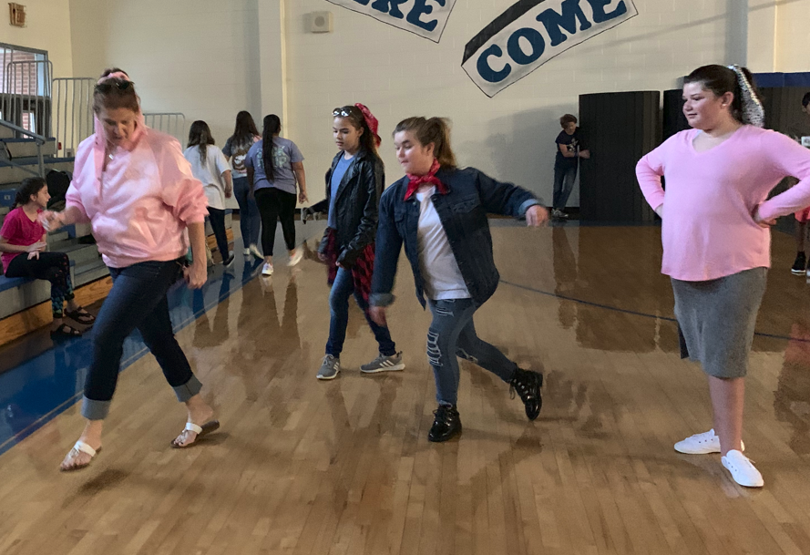 Ms. West teaching them dance steps