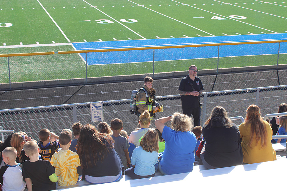 Chief Cole and junior fire fighter, Chase Utt demonstrate the equipment