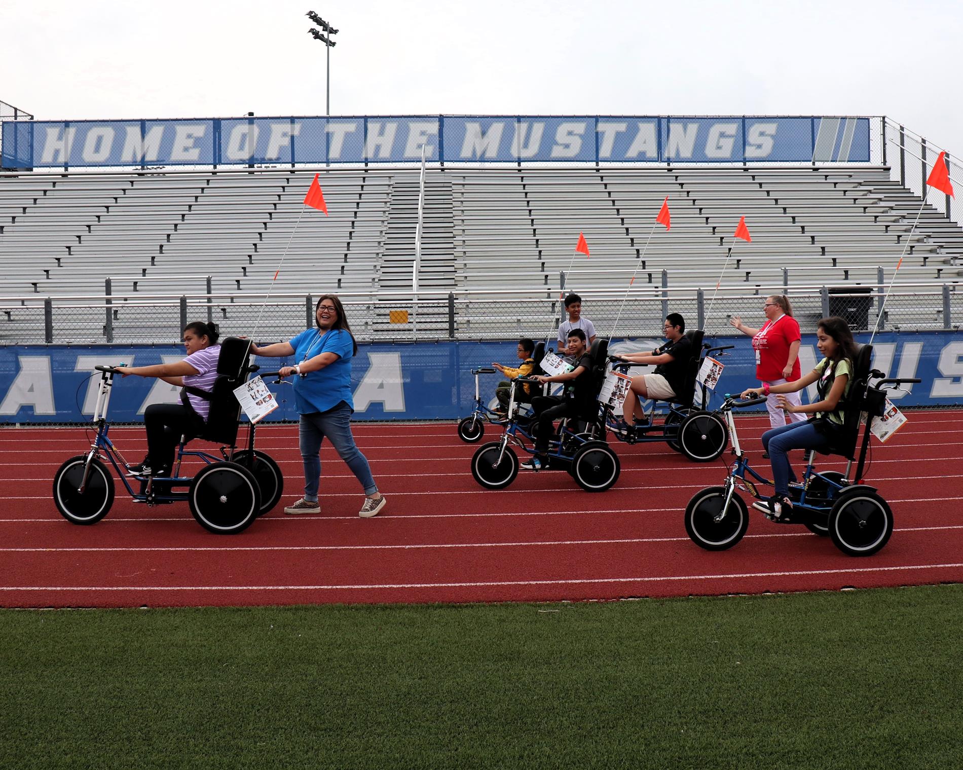 Students riding the adaptive bikes donated to the school