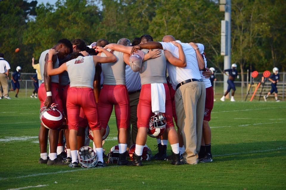 football team in huddle