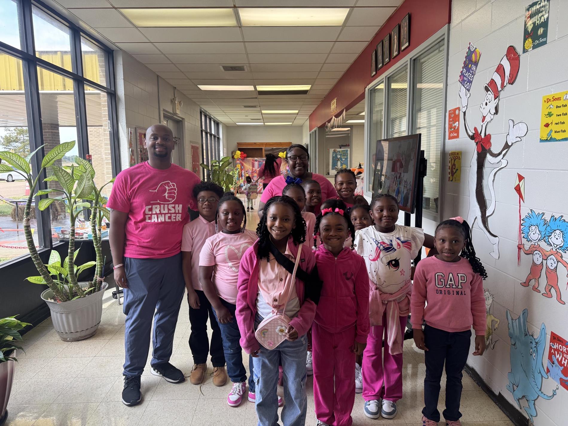 A class wearing all pink shirts for breast cancer awareness.