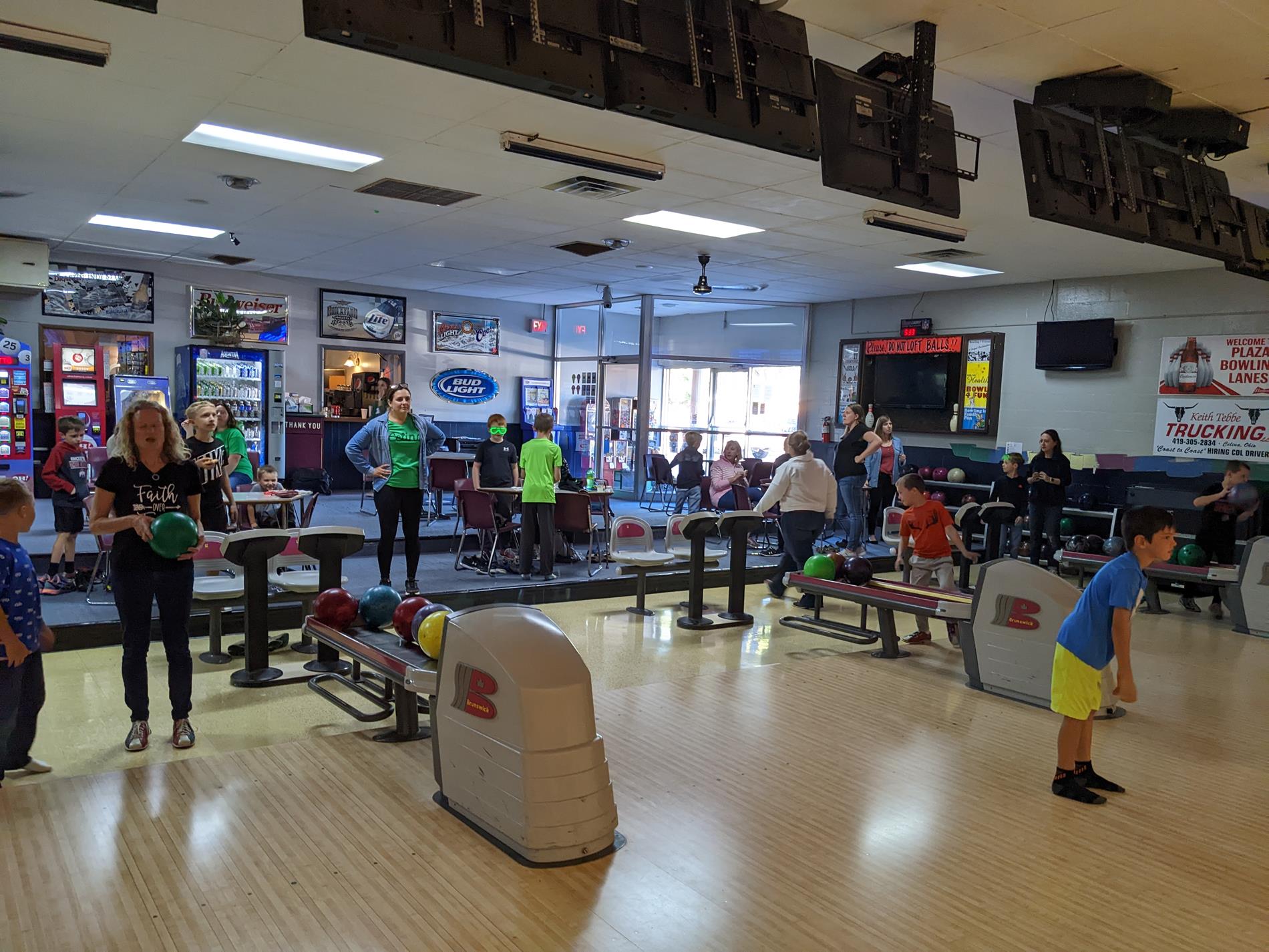 Young boys and moms at bowling alley