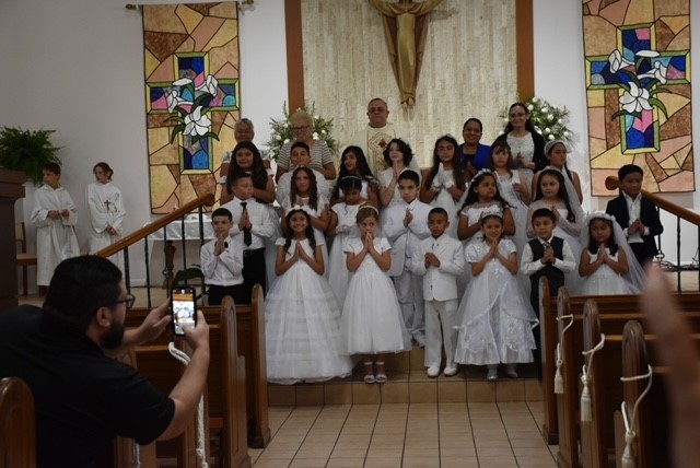 Children receive First Communion