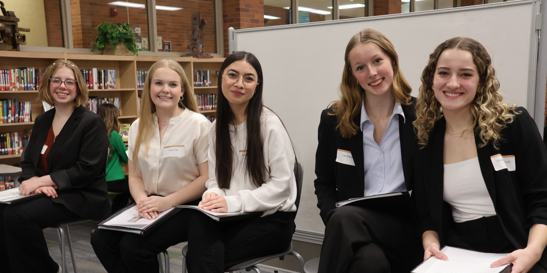 Students sitting in library preparing for mock interviews