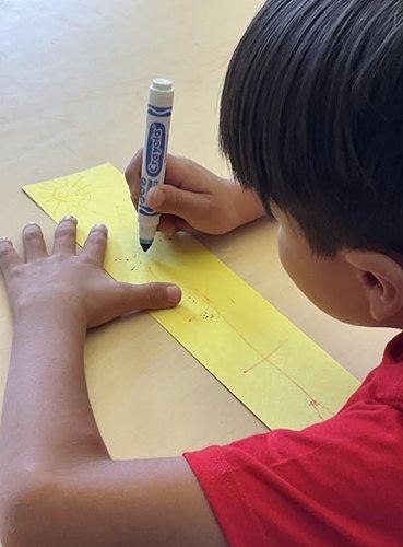 A student drawing with a marker