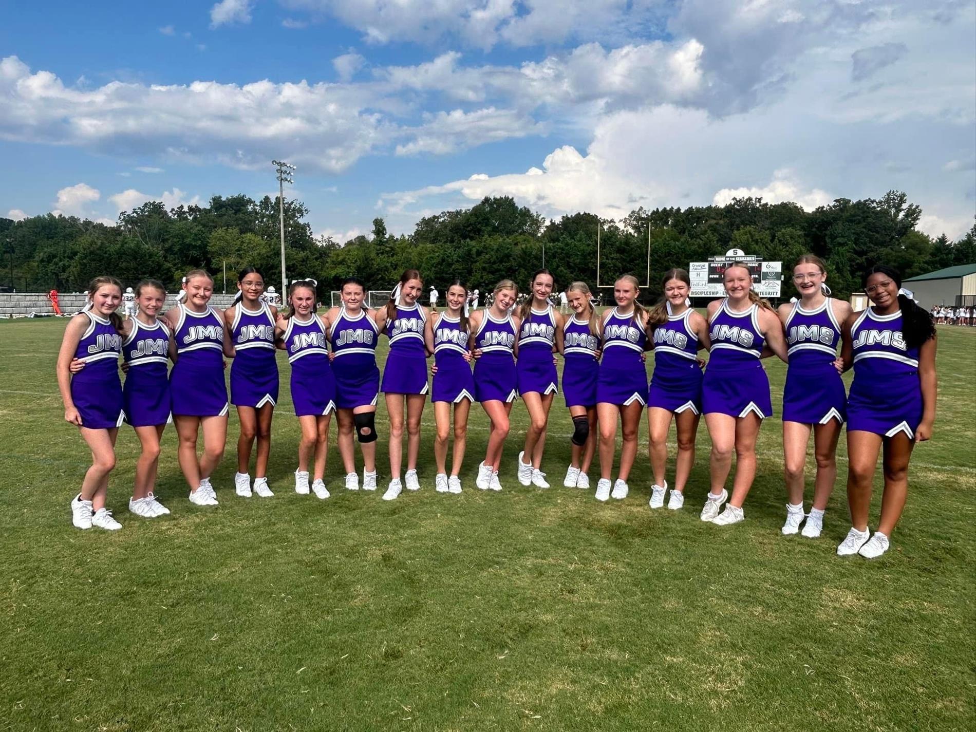 cheerleaders in uniform at football game