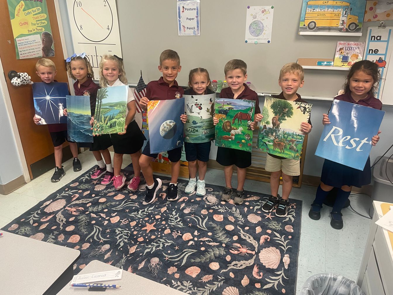 lower school students holding project