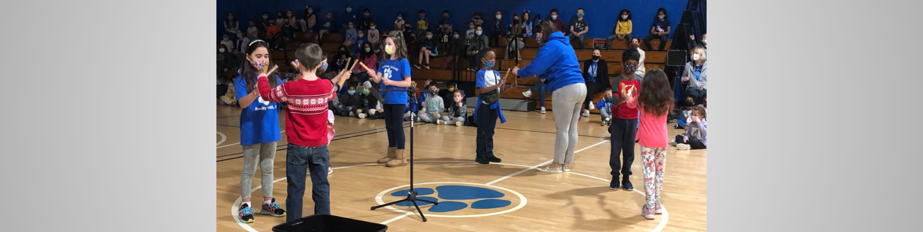 Students play musical instruments in a performance