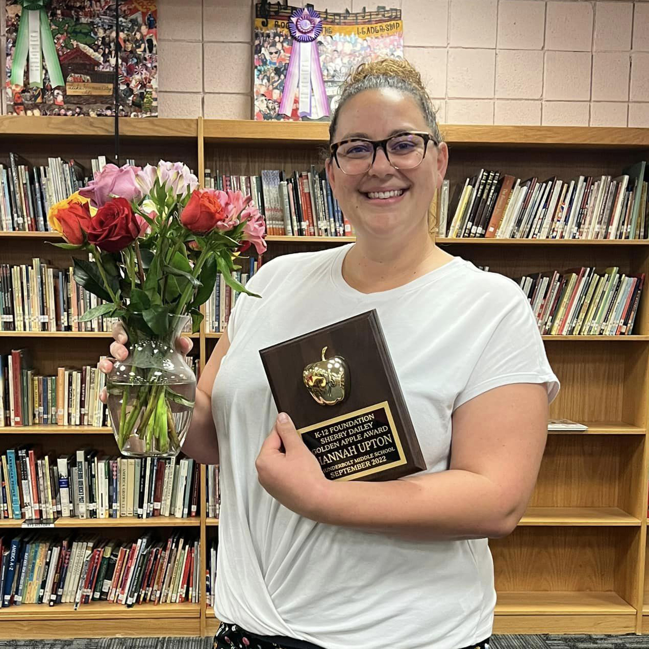 picture of Hannah Upton with flowers and Golden Apple Award plaque from K-12 Foundation