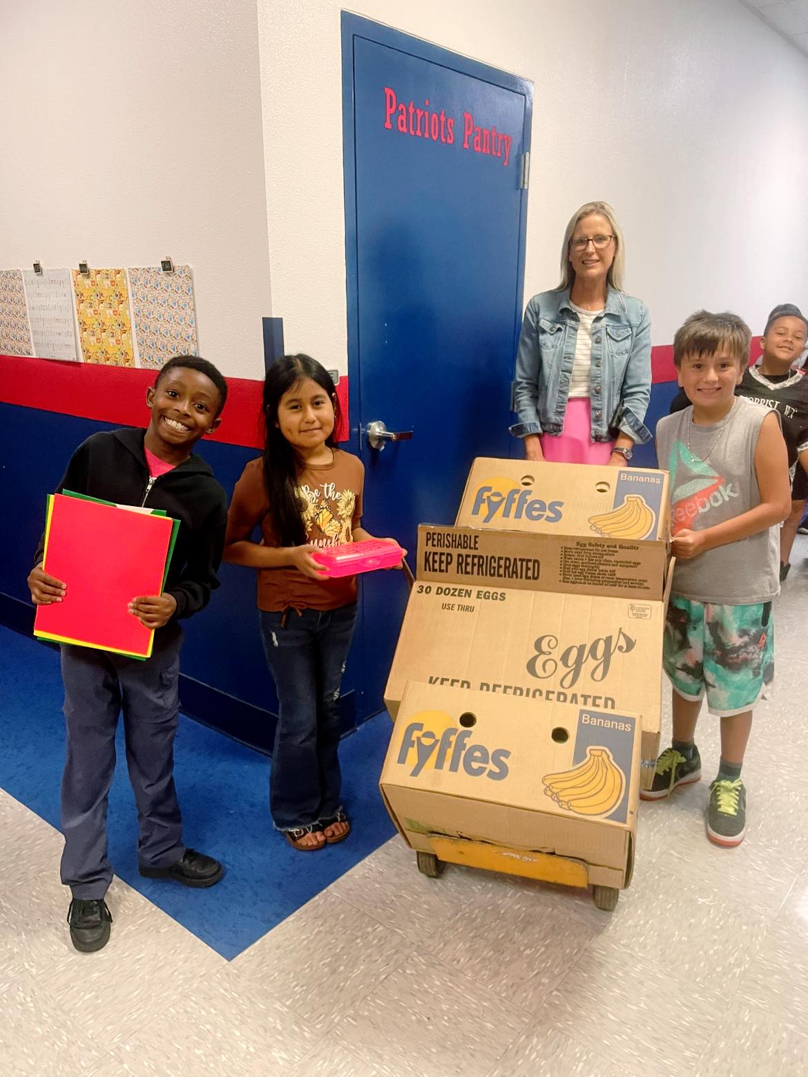 Students receive a donation of school supplies