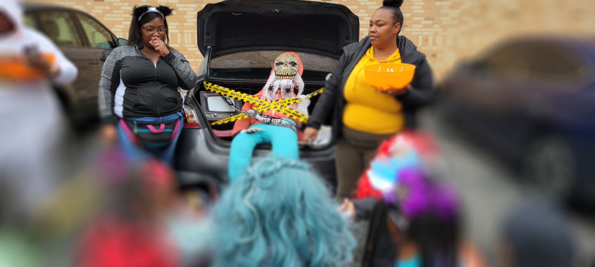Trunk or treat pictures.  Parents with a plastic skeleton in car