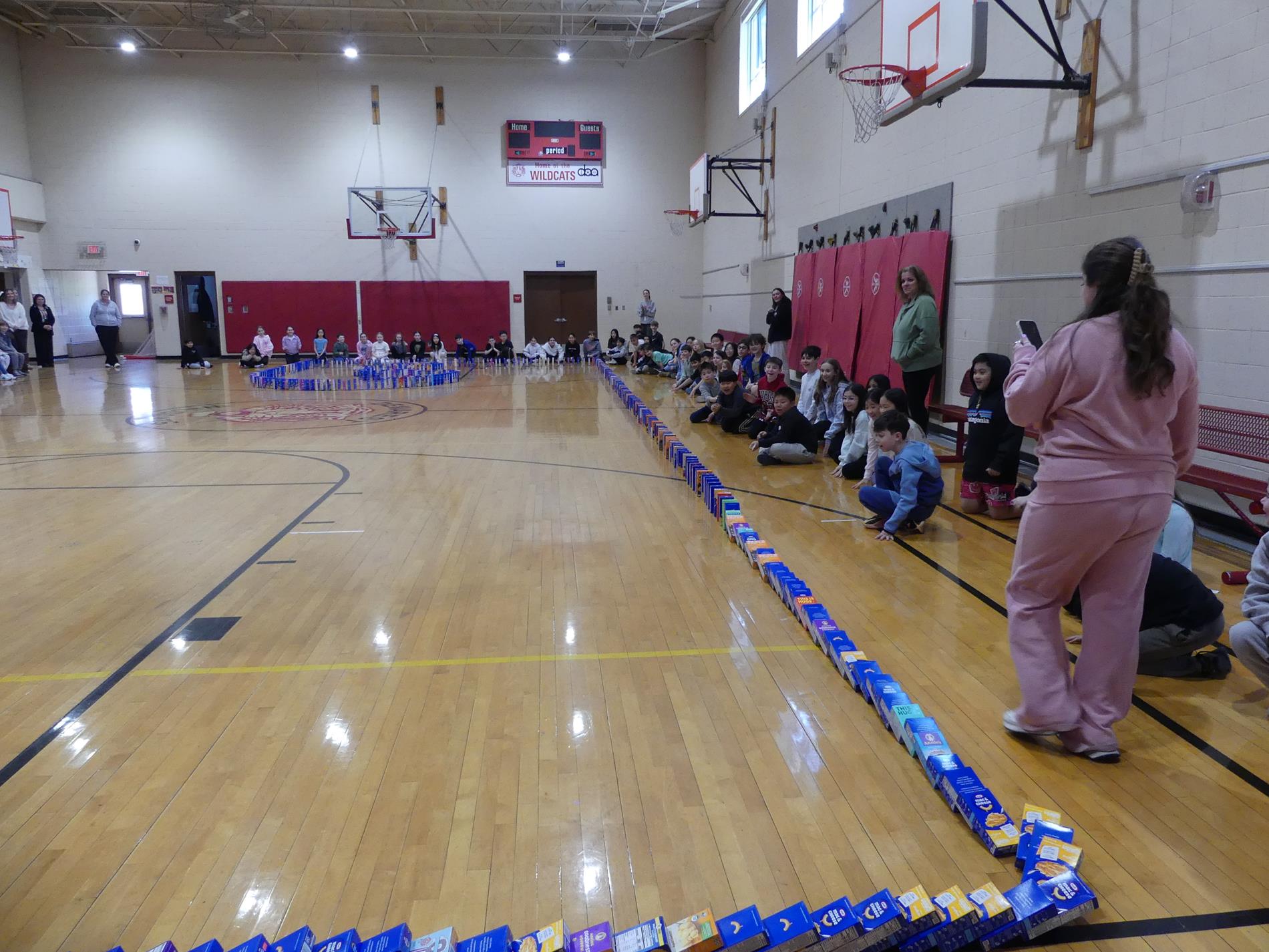 Macaroni & Cheese collection shows students and boxes set up like dominos