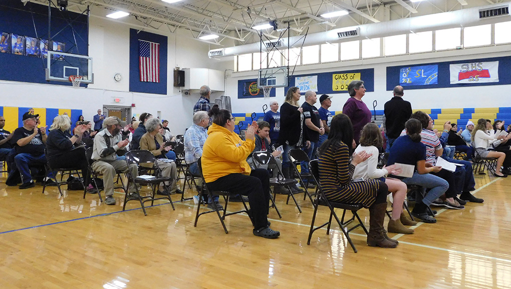 veterans stand to be recognized when their song is played