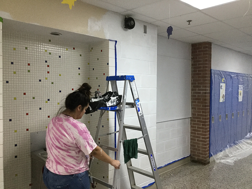 Students volunteering to help paint