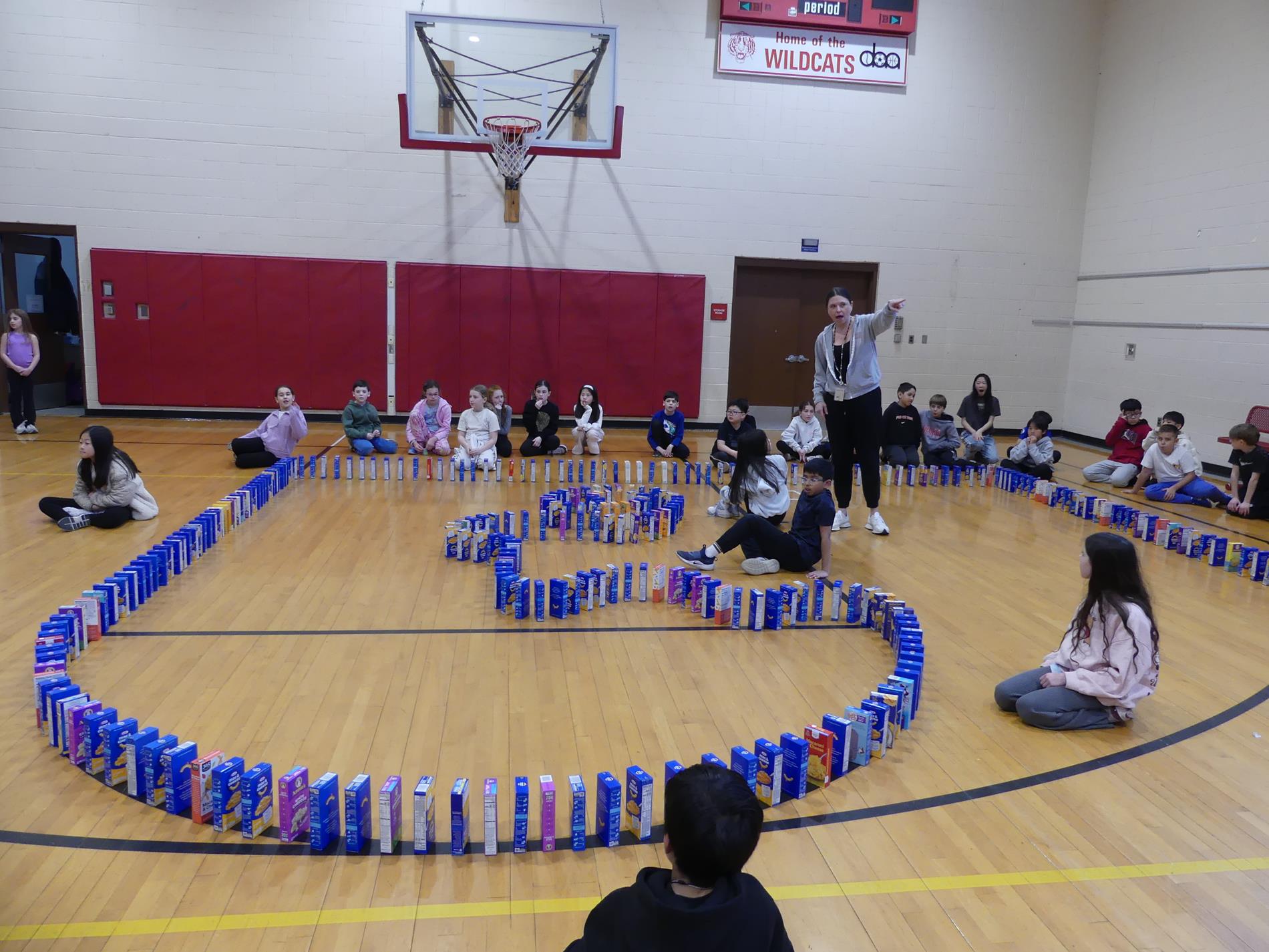 Macaroni & Cheese collection shows students and boxes set up like dominos