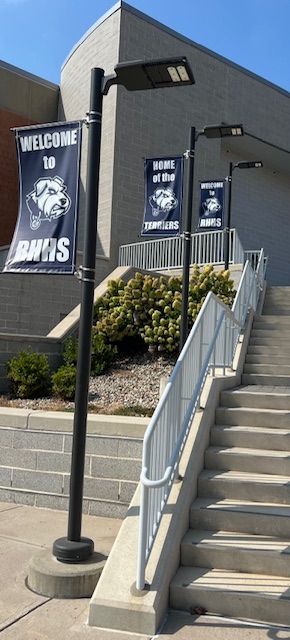 Walkway and flags leading up to the high school's main entrance Walkway and flags leading up to the high school's main entrance
