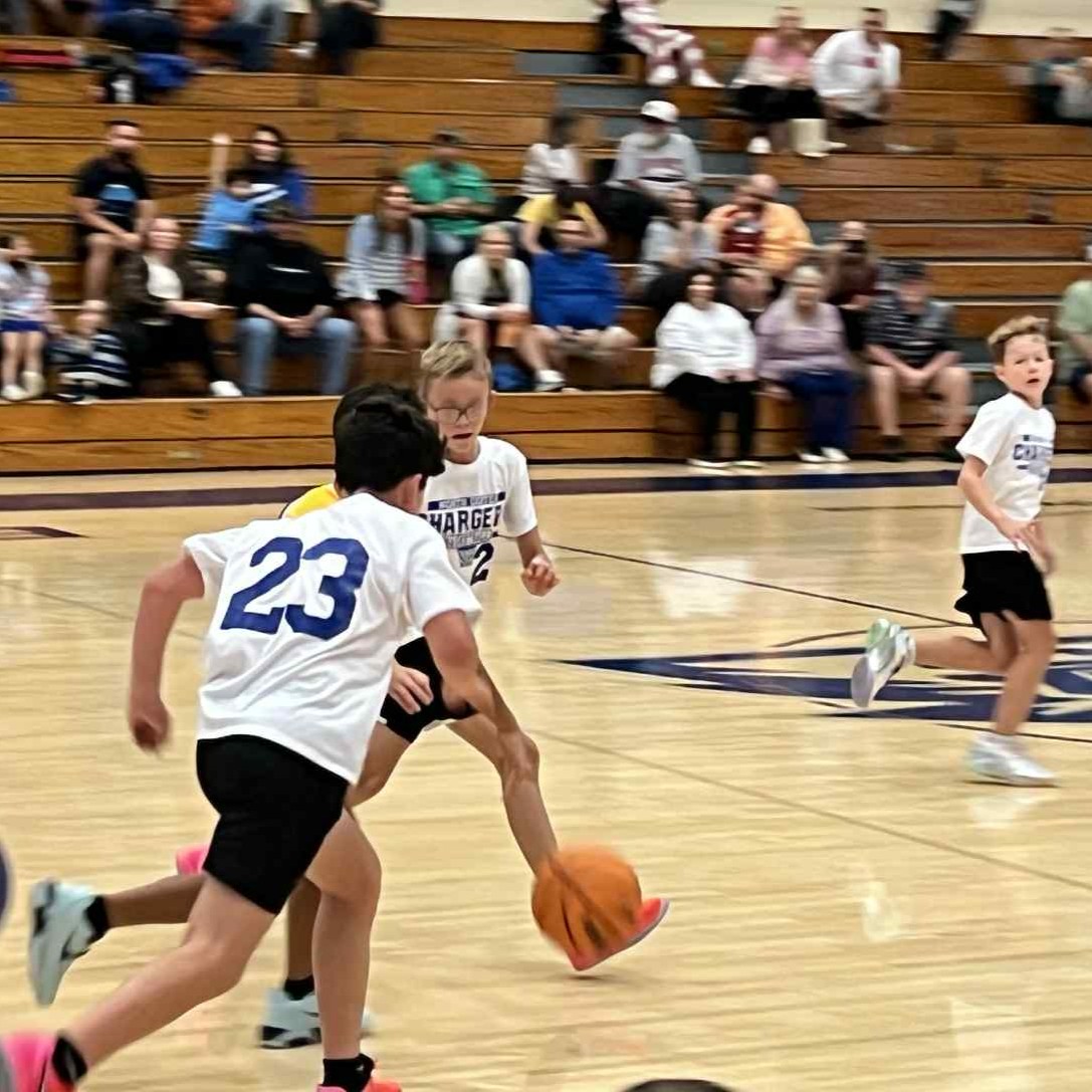 Boys basketball dribbling down court
