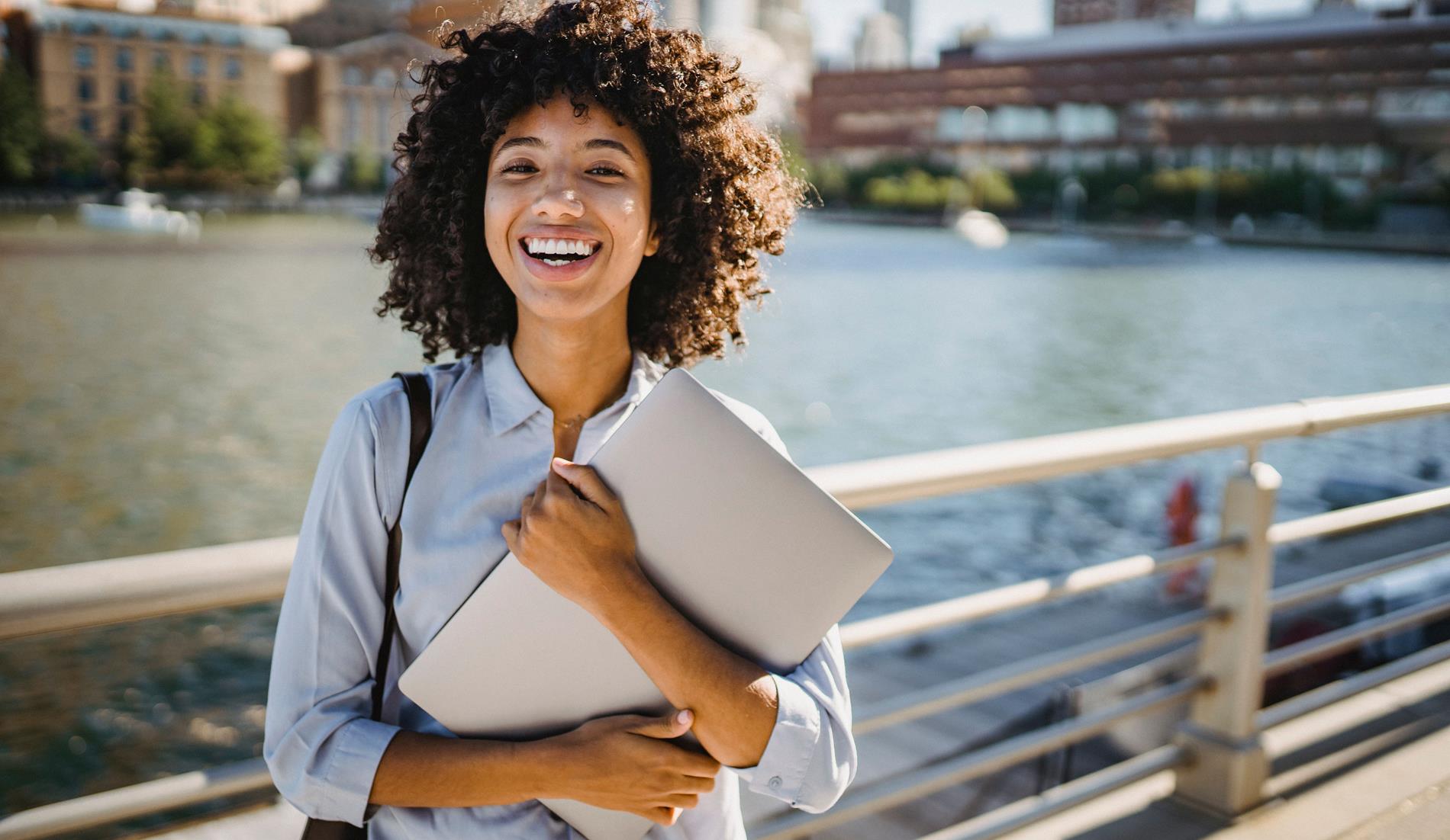 Photo of Student holding a laptop