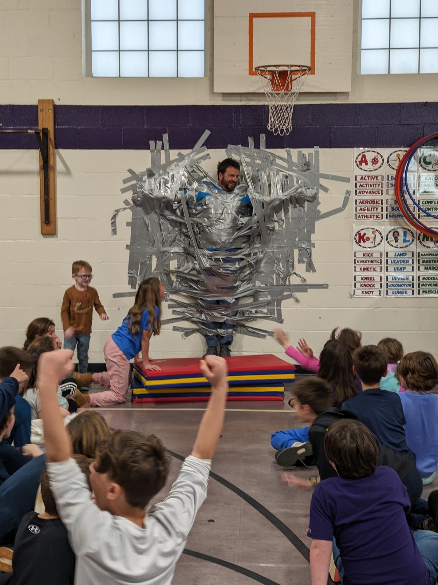 man duct taped to wall