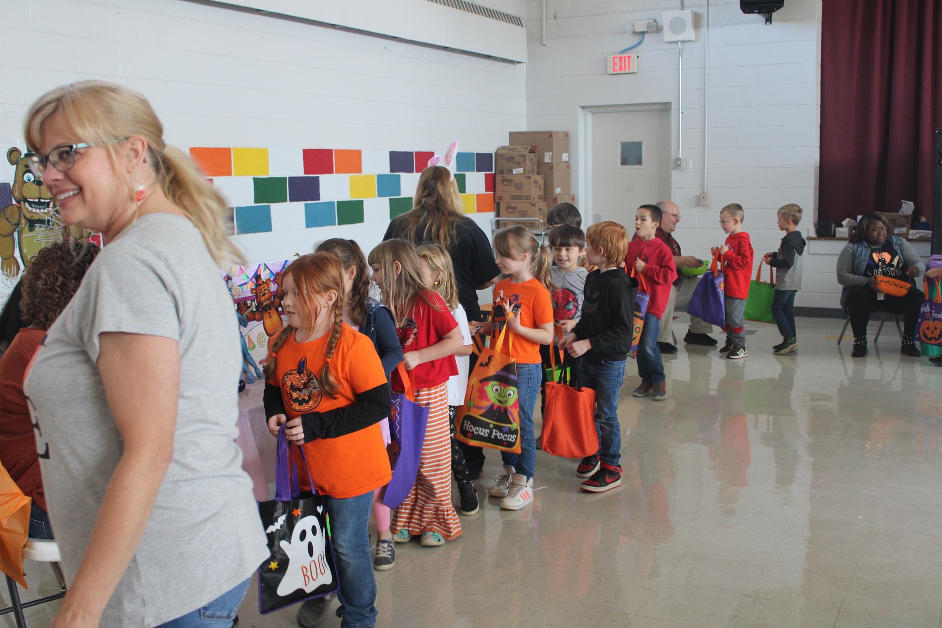 students lined up to trunk or treat in cafeteria at primary school