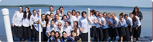 students in front of water