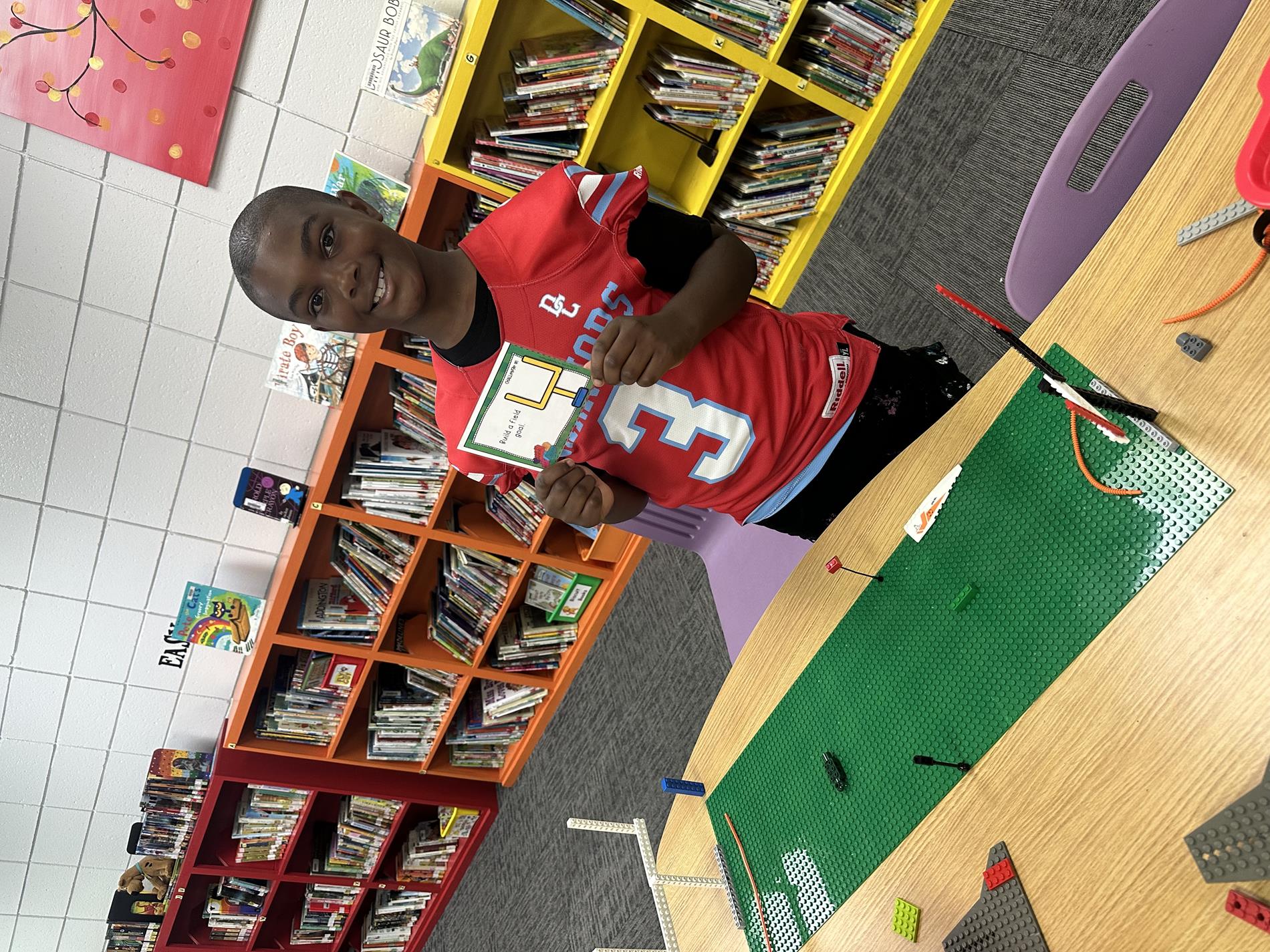 Student built a football field with building bricks.