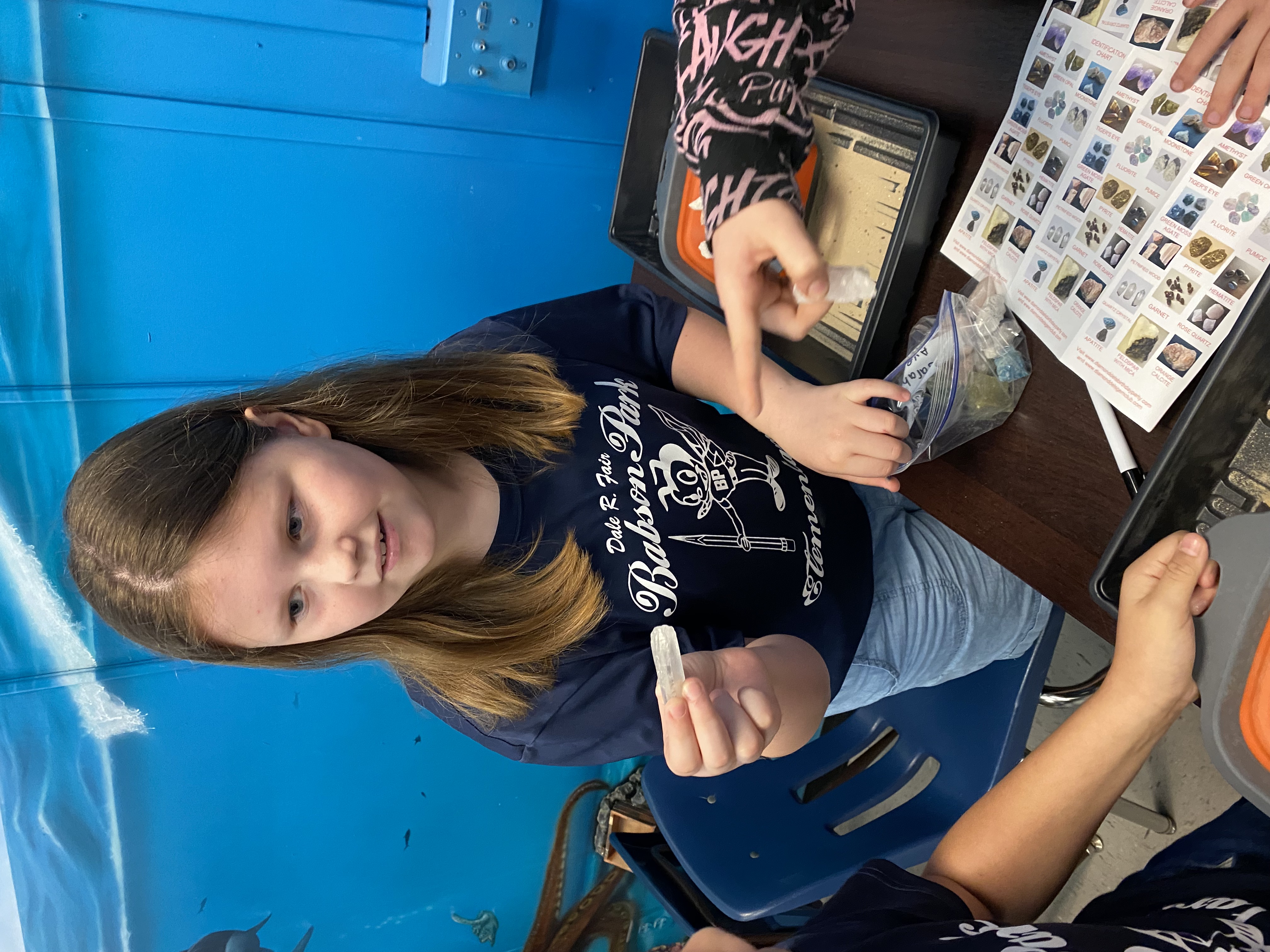 One of students excited to show off their findings from their mining for rocks and minerals.