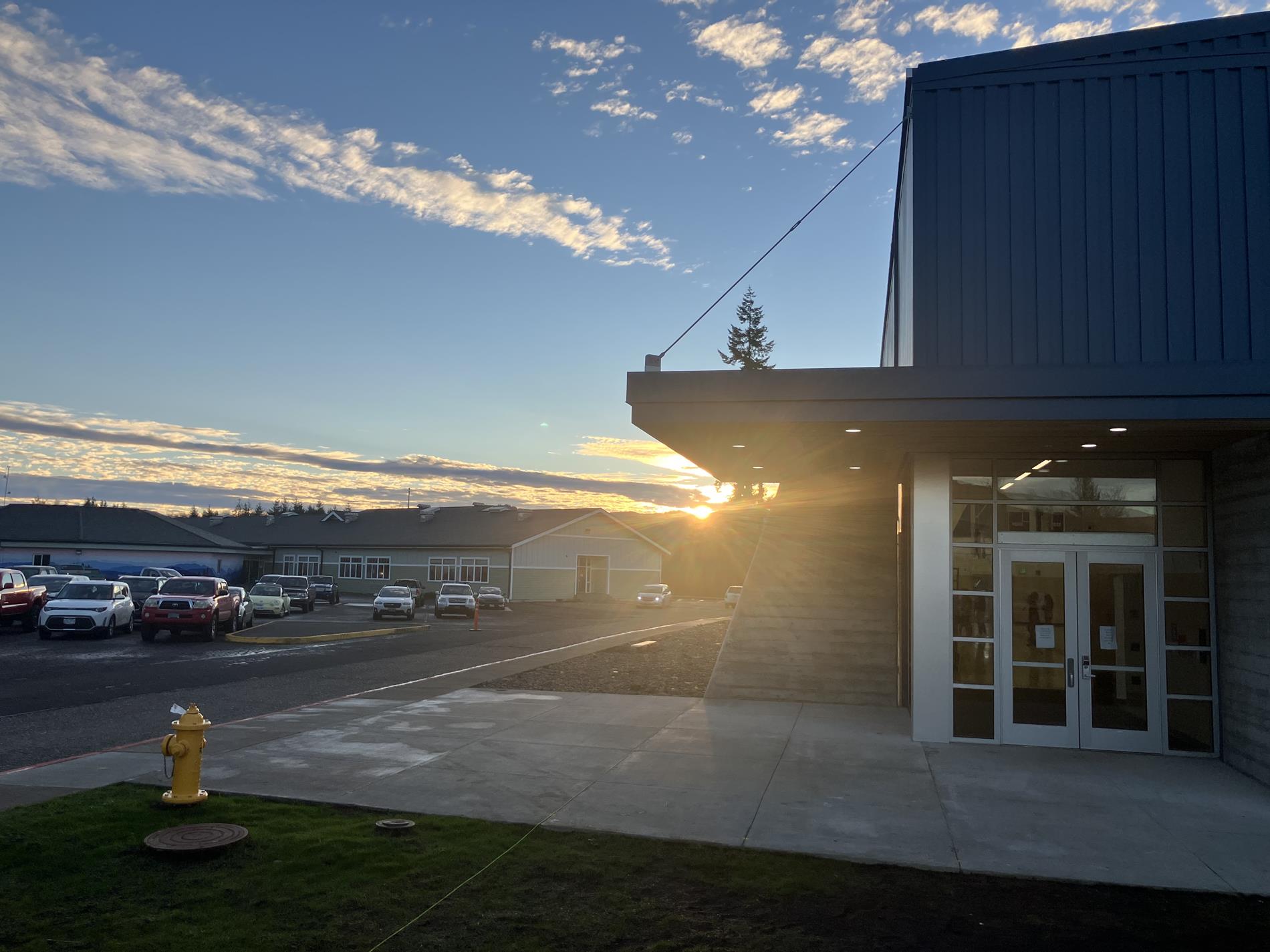 Sunset over the District Office parking lot, with flag