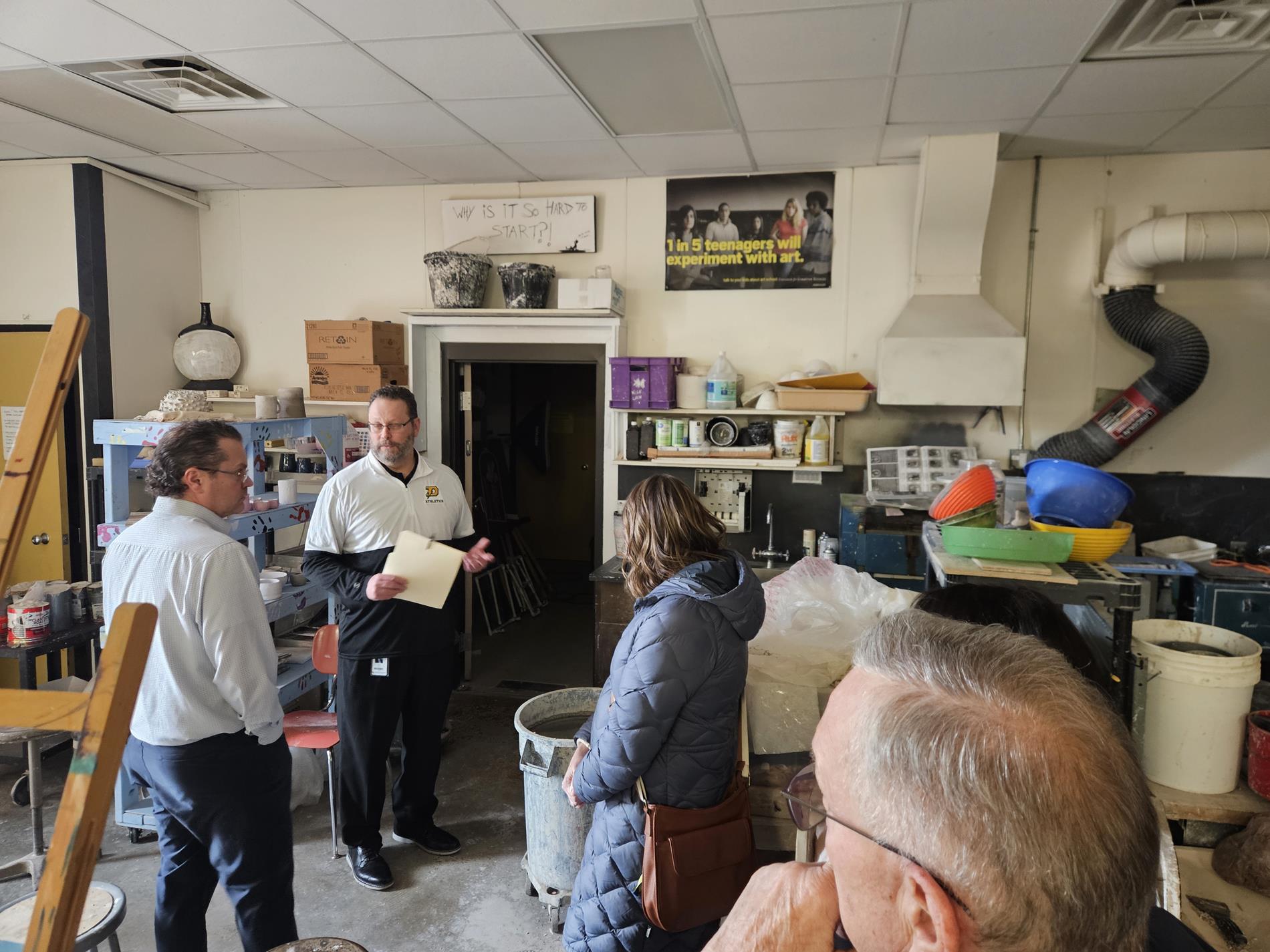 Steering Team members stand in the art room at Dow High School on their tour of the building