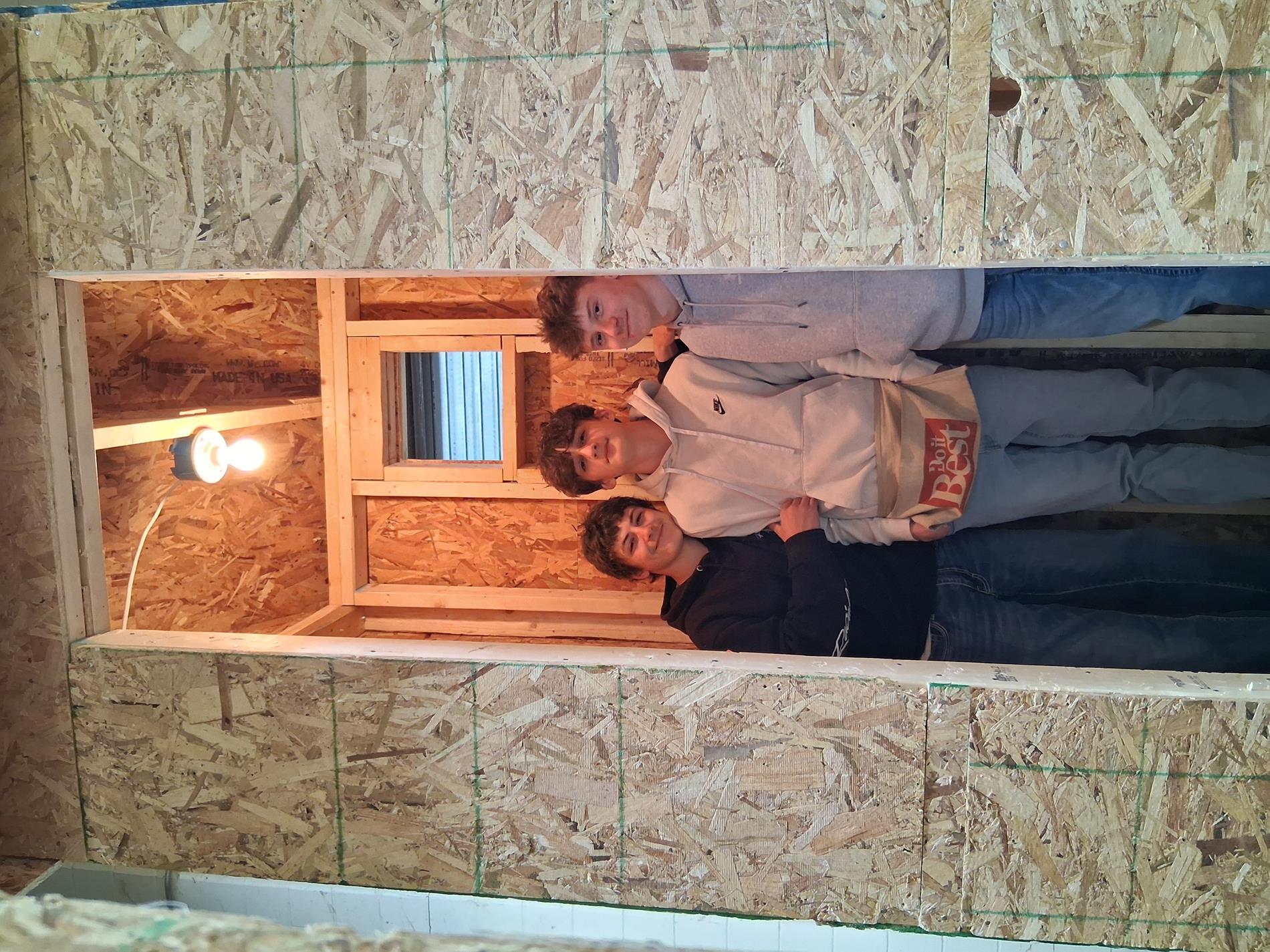 Intro to Construction students stand in front of the building they constructed.