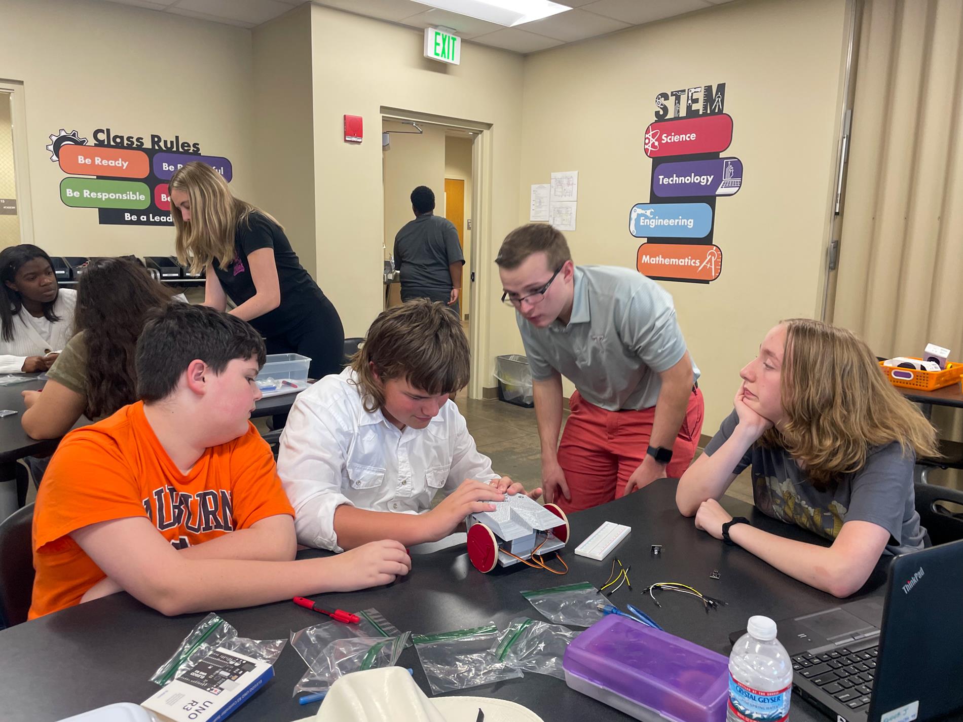 Troy University Electrical Engineering students help 8th-grade STEM students.