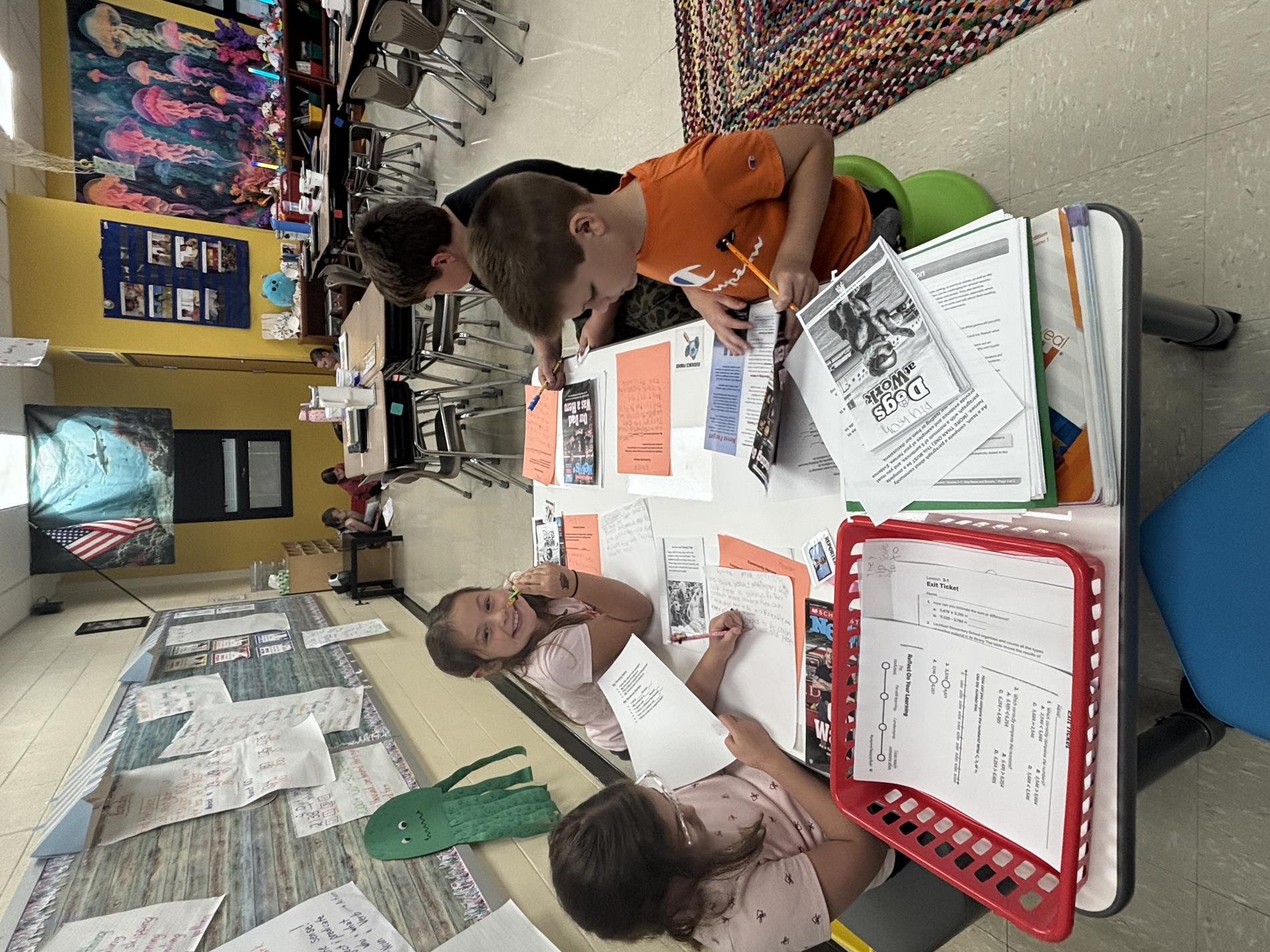 A group of third grade students working around a table.