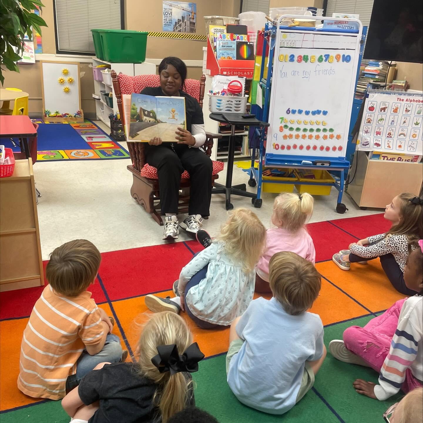 West Point Career and Technology Center Early Childhood Education student reading to young children