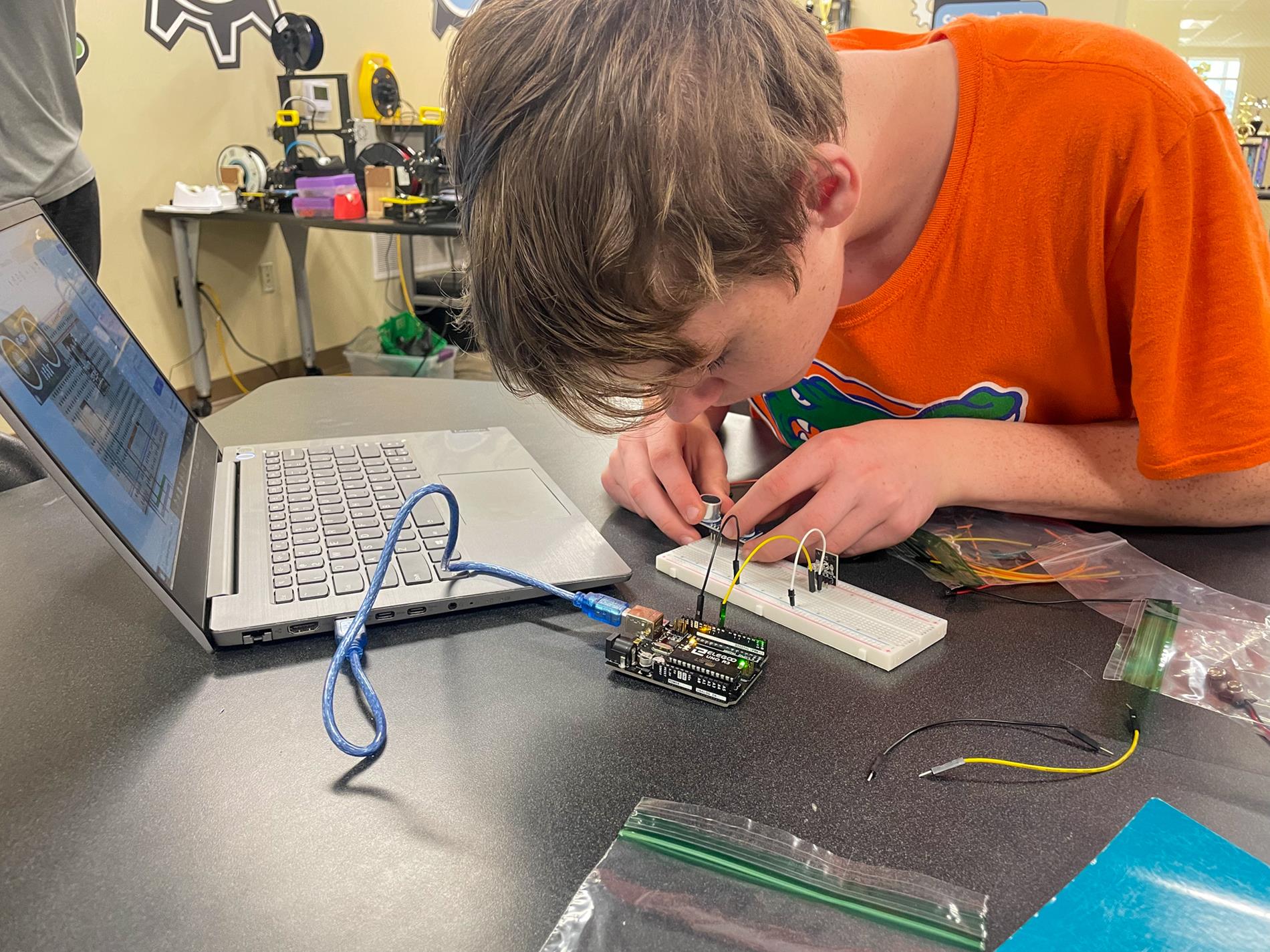 Troy University Electrical Engineering students help 8th-grade STEM students.