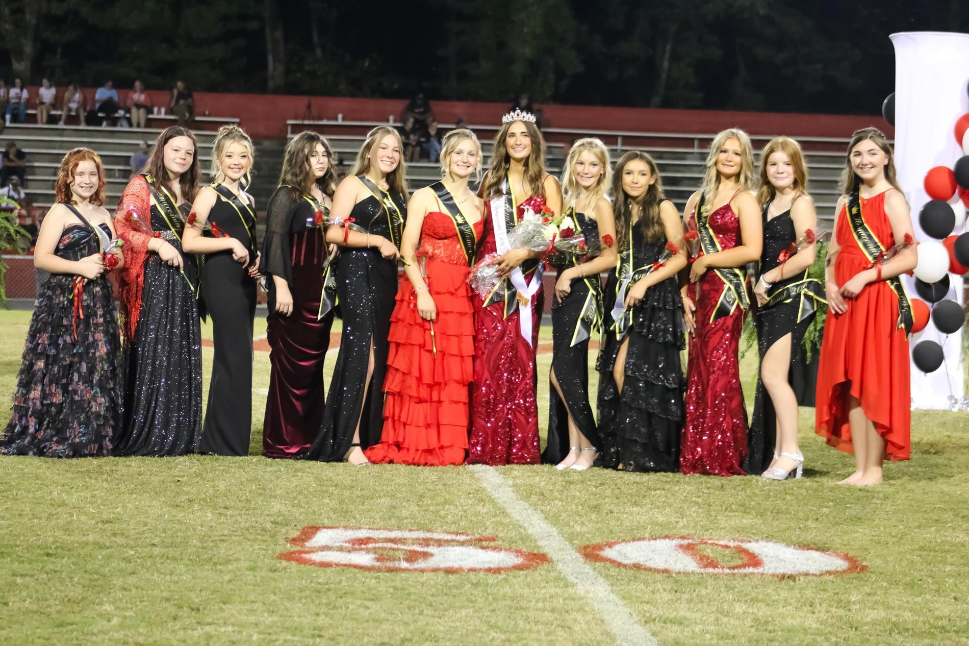 WMS Homecoming court wearing red and black dresses.