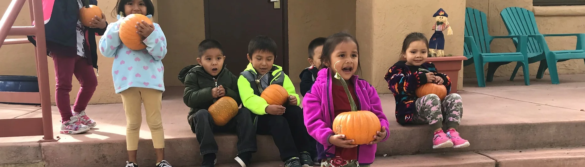 young students with pumpkins
