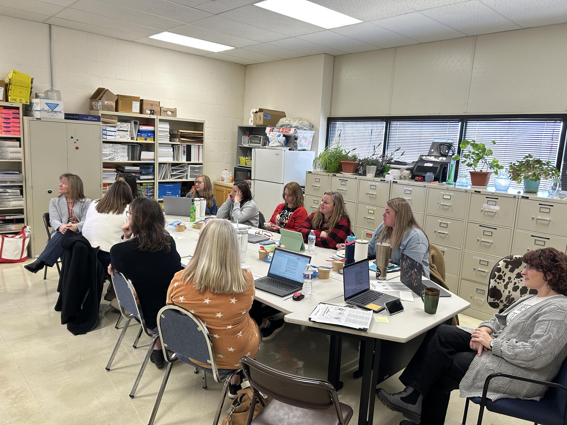 Principals sitting around discussion plans for their schools