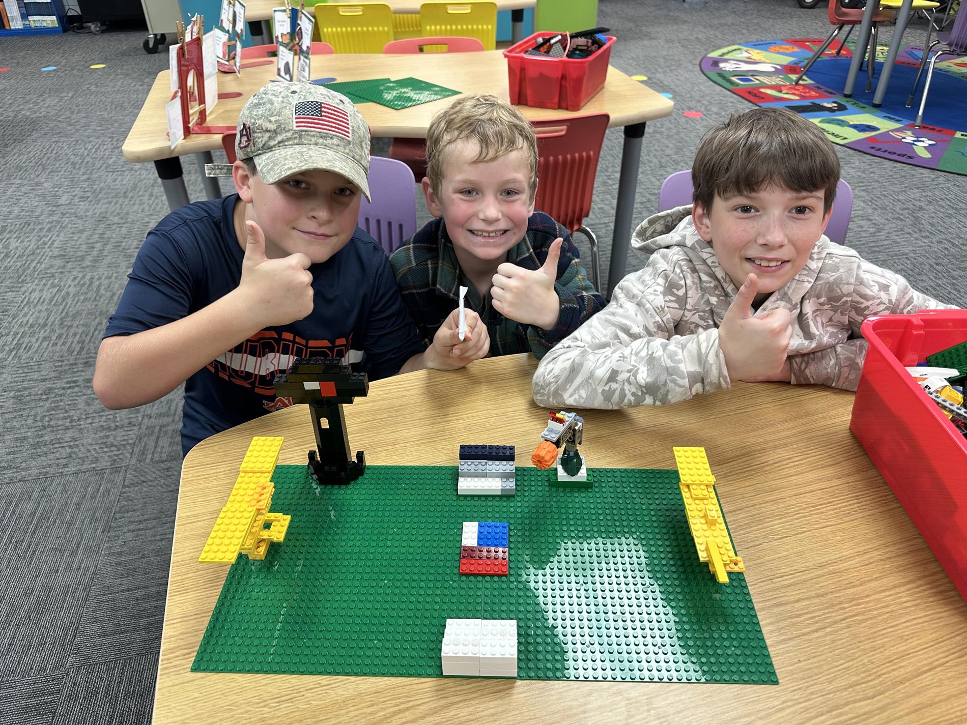 Students worked together to construct a football stadium with building bricks.