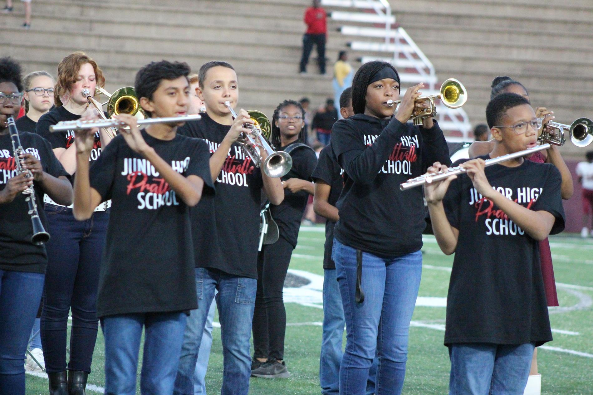 Pjhs band members playing assorted instruments at football game