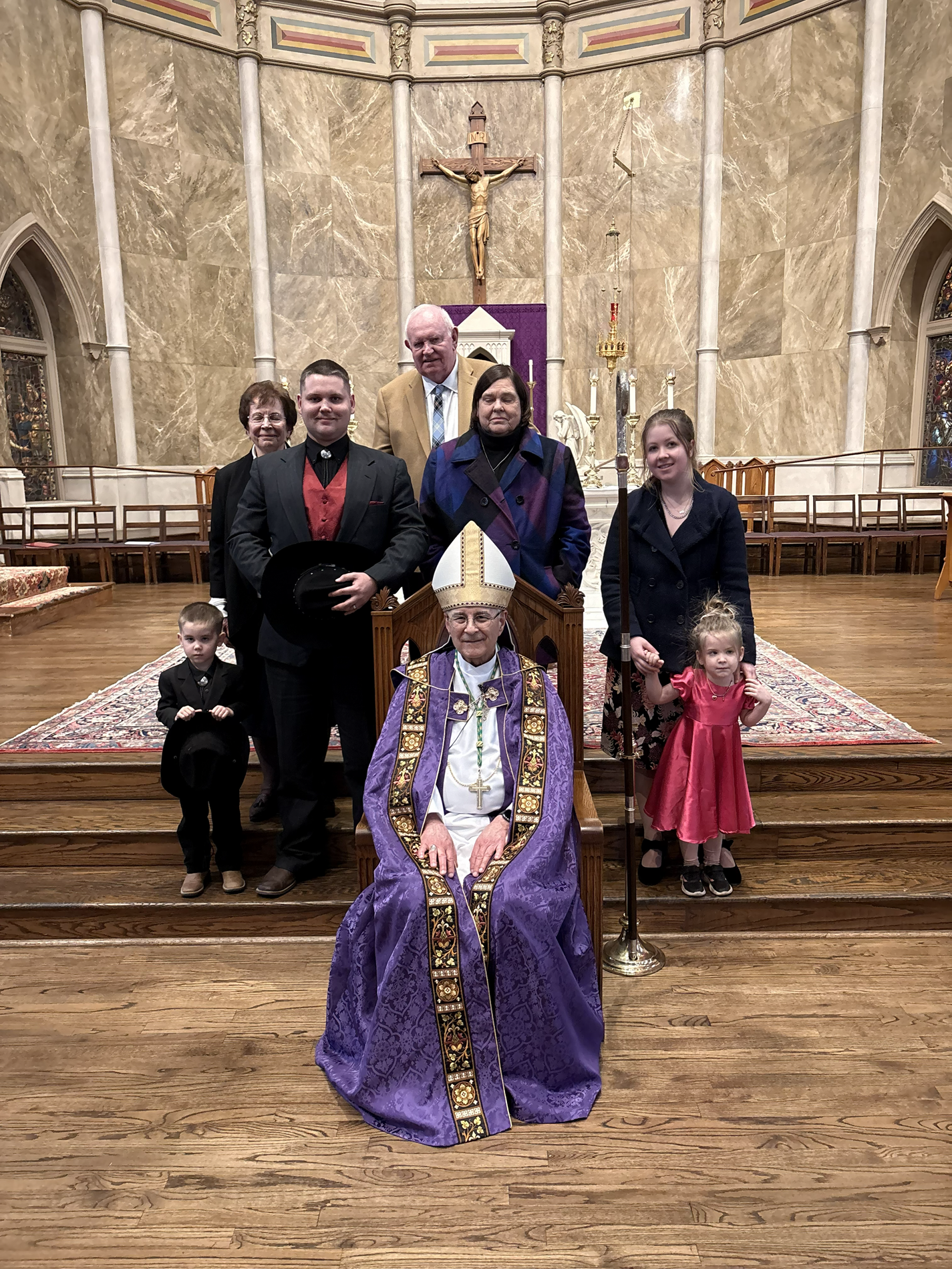 The Scott family and their faith support with Bishop Raica