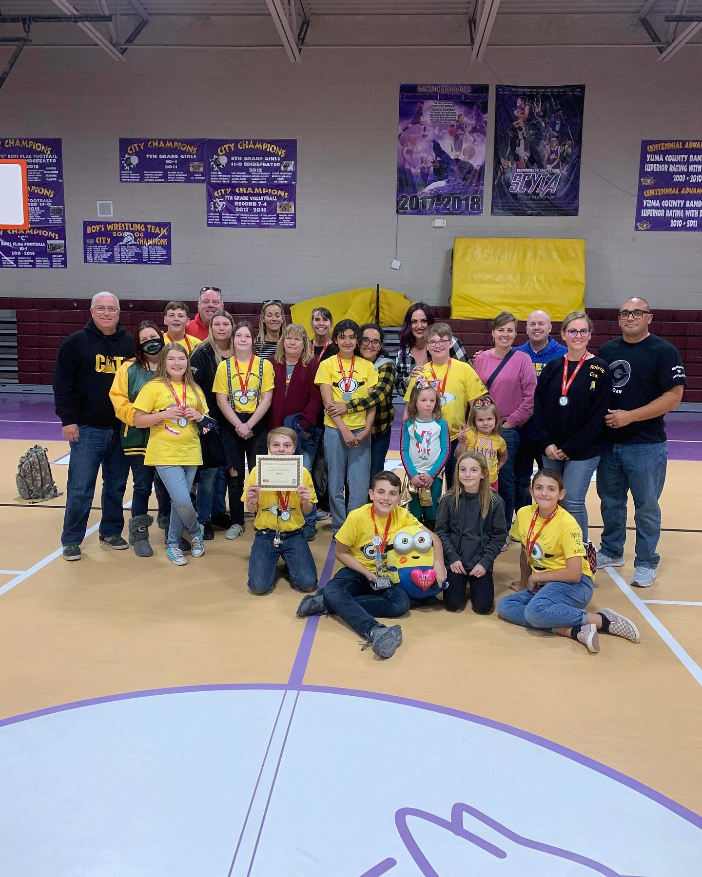 Mighty Minions robotics team with coaches and family
