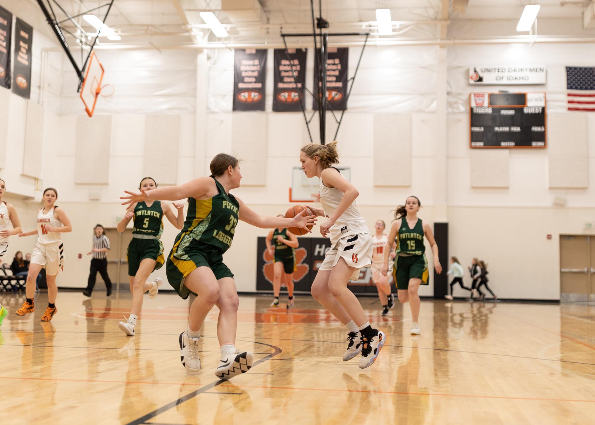 Girls basketball player dribbling on court