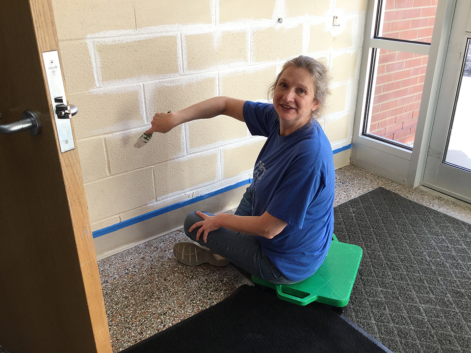 Mrs. Ronshak painting walls