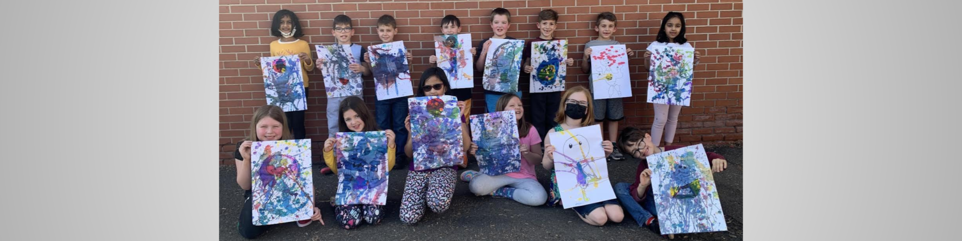 Students posing outside with their splash artwork