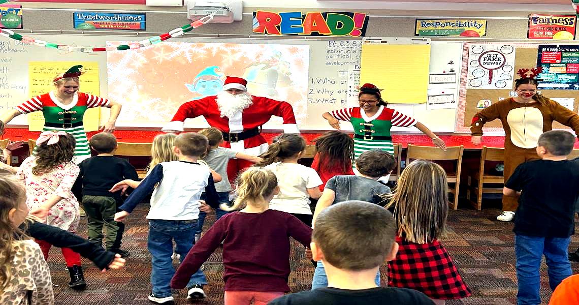 The annual holiday tradition of 8th grade students helping with the elementary library program 