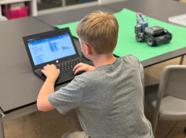 4th Grade ALPS Student coding VEX robot